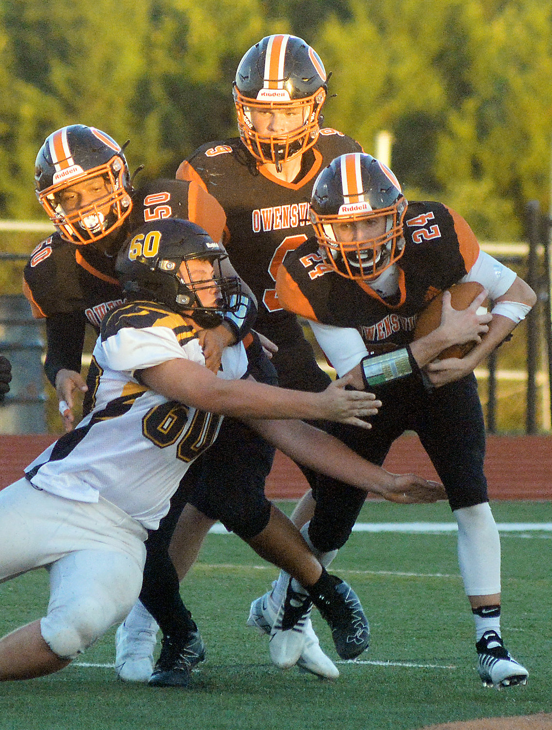 Tanner Meyer (far right) secures the football while looking for open field to run on.